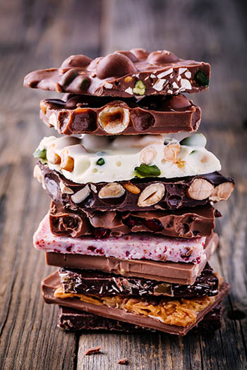 dark, white, and milk chocolate bark with nuts and fruit