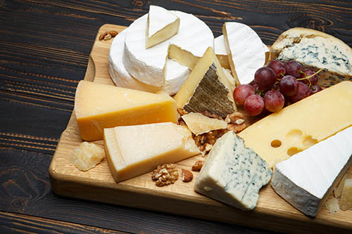 various cheeses on cheeseboard