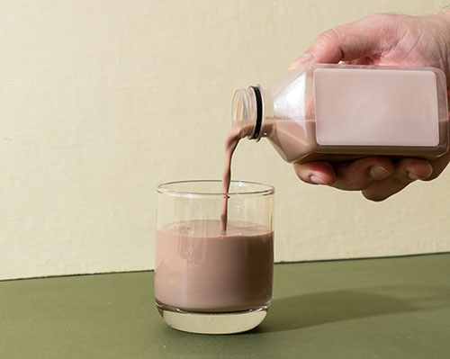 pouring a glass of chocolate milk