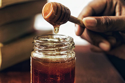 jar of honey with dripper