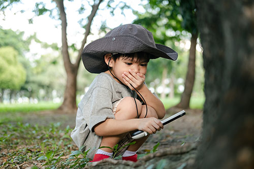 young boy with magnifying glass