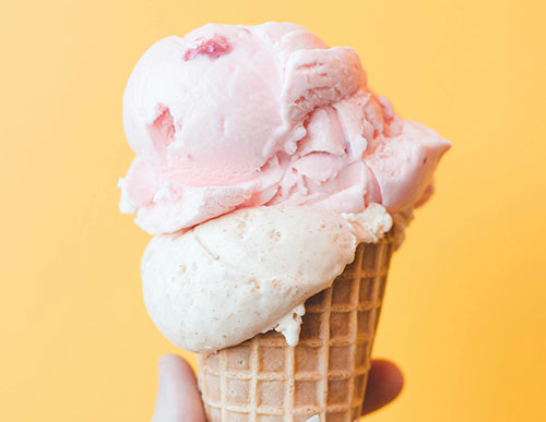 strawberry ice cream in a waffle cone